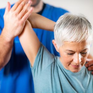 therapist-checking-senior-woman-s-arm-2Q5JSGB